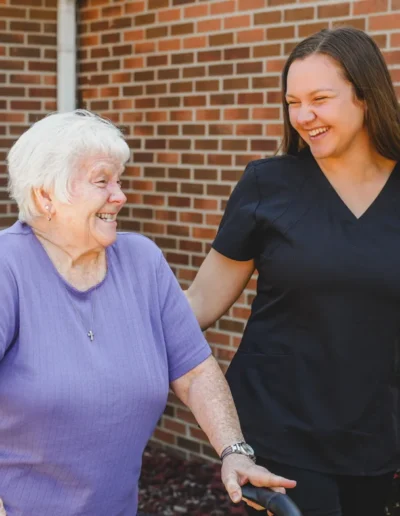 Caregiver walking with a resident outside